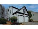 Side angle showcasing the home's two-car garage and well-maintained siding at 2587 Alvecot Cir, Atlanta, GA 30339