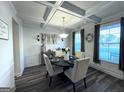 Well-lit dining room with coffered ceiling, table set for four, and neutral decor accents at 5257 Shorthorn Way, Powder Springs, GA 30127