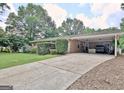 Spacious driveway leading to a brick home with covered parking at 260 Sharon Dr, Fayetteville, GA 30214