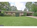 Charming brick home with a well-manicured front yard and covered parking at 260 Sharon Dr, Fayetteville, GA 30214