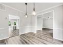 Dining room with wood floor and stylish pendant lights which leads to kitchen at 980 Charter Club Dr, Lawrenceville, GA 30043