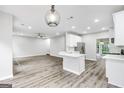 Modern open concept kitchen featuring an island and an open view to the living room at 980 Charter Club Dr, Lawrenceville, GA 30043