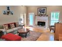 Inviting living room featuring hardwood floors, a fireplace, comfortable seating, and natural light at 223 Overland Trl, Mcdonough, GA 30252