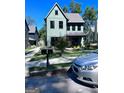 Modern two-story home with a well-manicured lawn, sleek mailbox, and a silver sedan parked nearby at 1225 Bridges Ave Sw, Atlanta, GA 30310