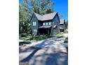 Beautiful modern two-story home with dark siding, sleek lines and a well-maintained lawn on a sunny day at 1225 Bridges Ave Sw, Atlanta, GA 30310
