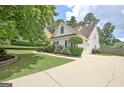 Long driveway leads to a well-maintained home with manicured landscaping and mature trees at 332 Aster Ridge Trl, Peachtree City, GA 30269