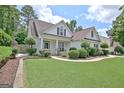 Beautifully landscaped yard frames this home with lush greenery and a well-maintained lawn at 332 Aster Ridge Trl, Peachtree City, GA 30269