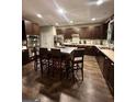 Modern kitchen features stainless steel appliances, dark wood cabinets and large kitchen island at 6131 Sparkling Cove Ln, Buford, GA 30518
