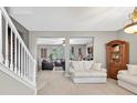 Bright open-concept living area featuring neutral walls and plush carpeting at 6131 Sparkling Cove Ln, Buford, GA 30518