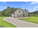 Spacious home with a long driveway and a three-car garage, surrounded by trees at 110 Sunflower St, Tyrone, GA 30290