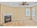 Comfortable living room features a cozy fireplace with a black hearth and mantle, along with sleek hardwood floors at 747 Gardenside Cir, Marietta, GA 30067