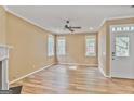 Spacious living room with hardwood floors, a ceiling fan, and an abundance of natural light from the many windows at 747 Gardenside Cir, Marietta, GA 30067