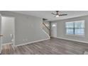 Bright and airy living room with hard surface flooring, staircase, and plenty of natural light at 7770 Hana Court Ct, Jonesboro, GA 30236