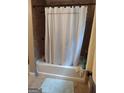 The bathtub with shower curtain offers a space for relaxation and hygiene at 5840 Butner Rd, South Fulton, GA 30349