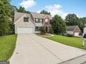 Beautiful suburban home with an extended driveway, two-car garage, and well-maintained landscaping at 942 Marta Crane Dr, Lawrenceville, GA 30045