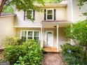Well-maintained townhome with a covered entryway and vibrant, manicured landscaping at 3150 Stratford Green Pl, Avondale Estates, GA 30002