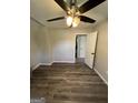 Bedroom with light gray walls, ceiling fan and wood-look flooring at 7128 Lady Heidi Ct, Jonesboro, GA 30236