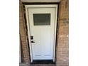 A new white door with glass pane is seen from the outside at 7128 Lady Heidi Ct, Jonesboro, GA 30236