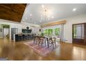 A dining area showcasing hardwood floors, ample lighting and natural light streaming through sliding glass doors at 2944 Braithwood Ne Ct, Atlanta, GA 30345