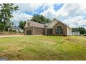 Lovely brick home with large front lawn and attached garage, blending comfort and curb appeal at 501 Llewellyn Ct, Jenkinsburg, GA 30234