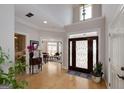 Grand foyer featuring hardwood floors, high ceilings, and a decorative front door with sidelights at 825 Chalet Hls, Mcdonough, GA 30253