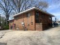 Back of brick house featuring patio and exterior access at 857 Grant Se Ter, Atlanta, GA 30315