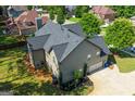 An aerial view of the rear of the home shows the roof, landscaping and attached garage at 145 Seawright Dr, Fayetteville, GA 30215