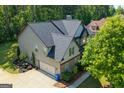 An aerial view of the side of the home shows the roof, landscaping and attached garage at 145 Seawright Dr, Fayetteville, GA 30215
