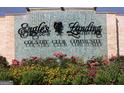 Community entrance sign for Eagle's Landing Country Club with stone accents and vibrant flower beds at 433 Abbey Springs Way, Mcdonough, GA 30253