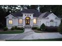 Elegant single Gathering home boasting well maintained lawn and circular driveway leading to the home's front entrance at 433 Abbey Springs Way, Mcdonough, GA 30253