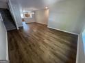 Open-concept living room featuring laminate flooring and views to the kitchen at 160 Odyssey Turn, Conyers, GA 30012