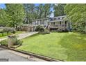 Two-story home with well-maintained lawn and mature trees in a peaceful neighborhood at 9138 Sunset Dr, Jonesboro, GA 30238