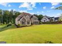 A luxurious home situated on a large lot, featuring a lush lawn and well-maintained landscaping at 150 Dean Dr, Tyrone, GA 30290