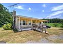 Attractive home with a covered porch, ramp access, and a well-manicured front lawn at 668 Spring Place Ne Rd, White, GA 30184