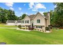 Expansive front lawn leads to a well-maintained home with mature trees at 345 Wynbrook Dr, Mcdonough, GA 30253