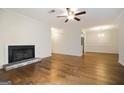 Living room featuring hardwood floors, a fireplace, ceiling fan, and open access to the dining room at 503 Countryside Se Pl, Smyrna, GA 30080