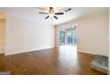 Empty living room featuring hardwood floors, a ceiling fan, and natural light at 503 Countryside Se Pl, Smyrna, GA 30080