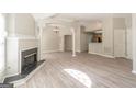 Bright open living space with fireplace, columns, neutral paint, and hardwood style flooring at 1392 Orchard Park Dr, Stone Mountain, GA 30083