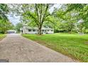 White, one-story home with lush lawn, long driveway and detached garage at 306 Tyrone Rd, Fayetteville, GA 30214