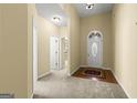 Spacious foyer with carpet, hardwood accents, and view of a bright interior at 545 Grand Teton Cir, Fayetteville, GA 30215