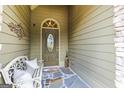 Inviting front porch with stone walkway, bench, and decorative wreath and door at 545 Grand Teton Cir, Fayetteville, GA 30215