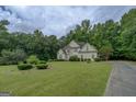 Two-story home set back from the road with a spacious front yard and mature trees at 235 Rustic Mill Ln, Fayetteville, GA 30214