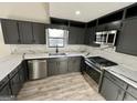 Beautiful kitchen with updated stainless steel appliances, gray cabinets, and counter tops at 295 Lamden Ct, Lawrenceville, GA 30046