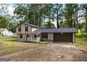 Two-story home featuring neutral siding, covered porch, attached garage, and concrete driveway at 770 Four Winds Ln, Jonesboro, GA 30238