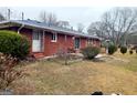 View of the spacious backyard with mature trees offering an outdoor space at 500 Circle Dr, Fayetteville, GA 30214