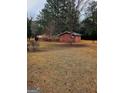 Exterior view of the outbuilding with a ample yard for storage and hobbies at 500 Circle Dr, Fayetteville, GA 30214