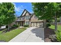 Charming brick home with well-manicured lawn and a two-car garage in a lush, green neighborhood at 5825 Trailwood Ct, Suwanee, GA 30024