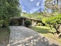 Home's driveway features a convenient carport and lush landscaping at 10173 Brass Ring Rd, Jonesboro, GA 30238