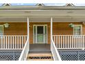Close-up of the front porch featuring flower pots and an inviting entrance at 2000 Stacia Dr, Covington, GA 30016