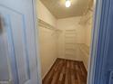 Spacious walk-in closet with wood floors and wire shelving for organization and storage at 10 Nicole Ct, Covington, GA 30016